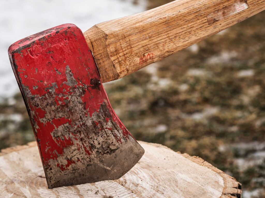 red ardex axe head in a stump